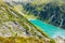 Beautiful alpine walley with azure blue water dam