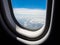 Beautiful altocumulus clouds view by looking through an airplane window.