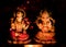 Beautiful ambient light on Ganesh and Lakshmi idols in dark. Diwali Concept