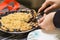 Beautiful American style blueberry pie, human hands taking a slice with a knife