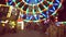 Beautiful amusement park at night, ferris wheel and carousel defocused.