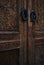 Beautiful ancient dark wood carved doors with round handles