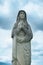 Beautiful ancient stone statue of Virgin Mary praying