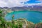 Beautiful andean plant chuquiragua, with an amazing view of lake of the Quilotoa caldera in the back. Quilotoa is the