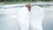 beautiful angel in white dress. Amazing blond woman with long curly hair and white wings. slow motion
