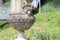Beautiful antic vase with women face in garden