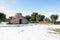 Beautiful Apulian landscape after snowfall, trullo and olive trees in an olive grove in the snow, unusual cold winter in Salento,