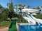 A beautiful aqua park with water slides and natural palm trees in a hotel in a warm tropical southern country resort