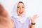 Beautiful arabian girl wearing hijab make selfie by camera over isolated white background very happy and excited, winner