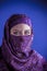 Beautiful arabic woman with traditional veil on her face, intens