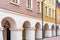 Beautiful arcades of tenement houses with colorful facades. Zamosc, Poland