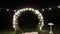 A beautiful arch for a wedding ceremony, at night with light from light bulbs