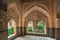 Beautiful arches, reliefs and tiles in arabic style, medieval interiors of the 14th century fortress of Alhambra