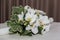 Beautiful arrangement of white orchids, green leaves and a candle