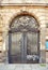 Beautiful art nouveau door gate with ugly graffiti