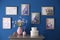 Beautiful artworks hanging on blue wall in room. Interior design