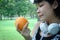 Beautiful Asia woman sport holding orange fruits for healthy food concept