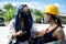 Beautiful Asian Architect Engineer women in yellow hard hat has conversation chat client manager