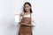 Beautiful Asian Barista waitress demonstrating mobile cell phone on white background