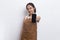 Beautiful Asian Barista waitress demonstrating mobile cell phone on white background