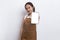 Beautiful Asian Barista waitress demonstrating mobile cell phone on white background