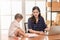 Beautiful Asian business mom is using a laptop  while spending time with her cute baby boyat home for quarantine from virus crisis