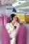 Beautiful Asian business woman listen music by mobile phone during flight in aeroplane. working, travel, business