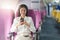 Beautiful Asian business woman listen music by mobile phone during flight in aeroplane. working, travel, business