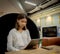 Beautiful asian businesswoman in close-up shot is training on a tablet in a serious pose while sitting.