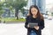 Beautiful asian businesswoman wear black suit using tablet outside office. woman freelancer lifestyle human urban.