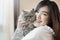 Beautiful asian  cat lover woman is playing with cat in her room