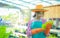 Beautiful asian farmer stands amidst her bountiful vegetable garden, holding up some of the freshly harvested organic produce in