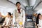 Beautiful Asian female cabin crew air hostess serving food and drink beverage to passengers on airplane, flight attendant push