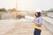 Beautiful Asian female engineer in white safety hard hat doing job at construction site outside office. Idea for modern working