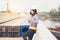 Beautiful Asian female engineer in white safety hard hat doing job at construction site outside office. Idea for modern working