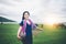 Beautiful Asian girl holding fish trap and basket, prepare to catch fish walking in field near lake