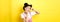 Beautiful asian girl showing v-sign and pouting cute, making silly face with makeup, standing on yellow background