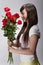 Beautiful asian girl sniffing roses