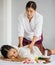 Beautiful Asian lady lying relaxedly and enjoy Thai massage. Thai massage is for healing and relaxation. The Thai massage is