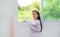 Beautiful asian little kid girl at home lying at window of house