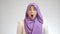 Beautiful Asian muslim lady wearing hijab shows surprised or shocked expression with open mouth