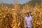 Beautiful Asian senior woman with sun glasses action for photograph near corn filed  smart farmer take photo in corn field ready