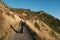 Beautiful asian tourist take some picture at Nugget Point, Dunedin, New Zealand. Young asian traveller enjoys walking in morning