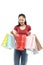 Beautiful asian woman bring many shopping bag colorful and open the bag with happy expression