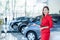 Beautiful Asian woman or car salesman Stand holding a new car remote key in the showroom, Cars For Sale