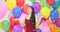 Beautiful asian woman dancing with colorful balloon background at the party in slow motion.