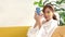 Beautiful Asian woman doing spa at home holding a smartphone