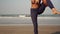 Beautiful asian woman doing yoga on the beach. The girl does asanas