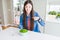 Beautiful Asian woman eating fresh green peas with surprise face pointing finger to himself