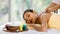 Beautiful Asian woman enjoy getting an oil massage happily in a spa. Relaxing and healing with Thai massage and aroma oil. Body